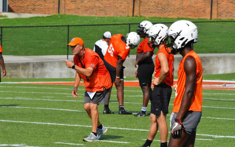 Taz Dixon coaches up defensive backs during last season’s summer workouts.