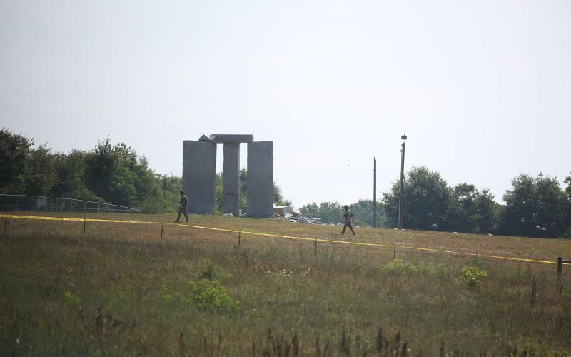 Members of the Georgia Bureau of Investigation bomb disposal unit scan the scene at the Georgia Guide Stones, one of which apparently exploded Wednesday morning.