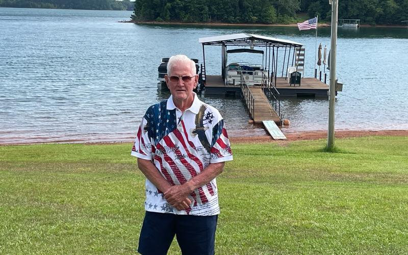 Hartwell staple Vinson Brown stands in front of his pristine lake front property in Hartwell.