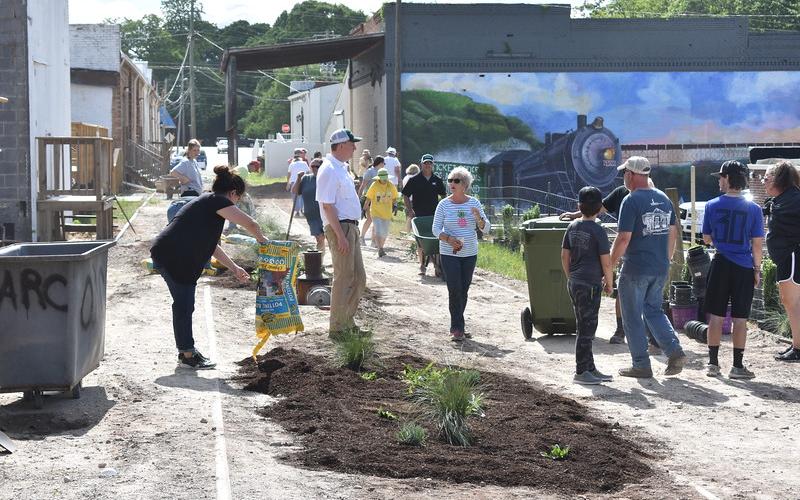Residents turned out to help install plants in a new garden, part of a downtown streetscape in Hartwell, designed by UGA engineering students.