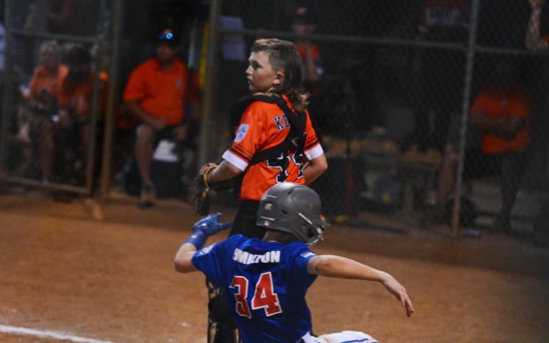 Easton Kelley scans the bases after getting the force-out at home.