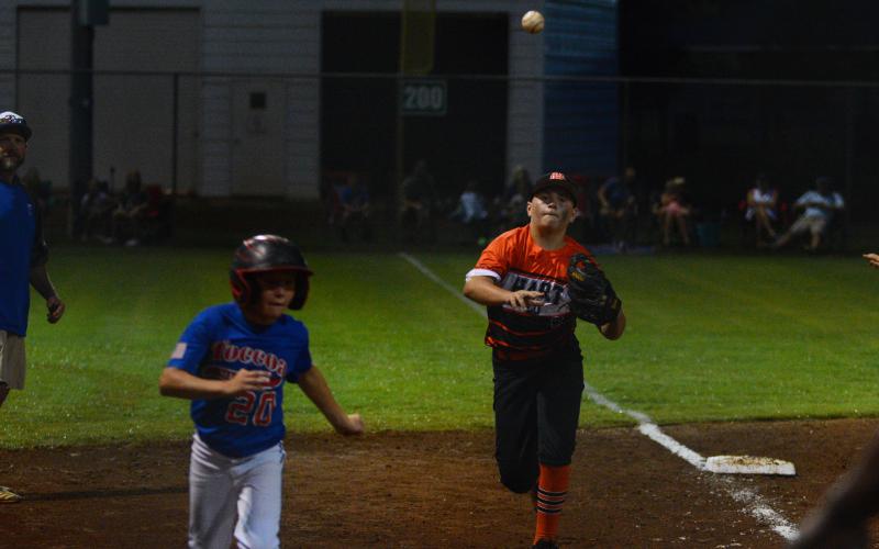 Wyatt Harrell catches a Toccoa player in a rundown between third and home.