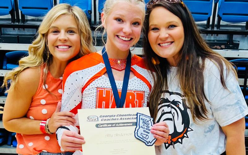 Ally Anderson (center) with her coaches Mollie Payne (left) and Ashley Risner (right) at the competition in Columbus on Saturday, Aug. 6.