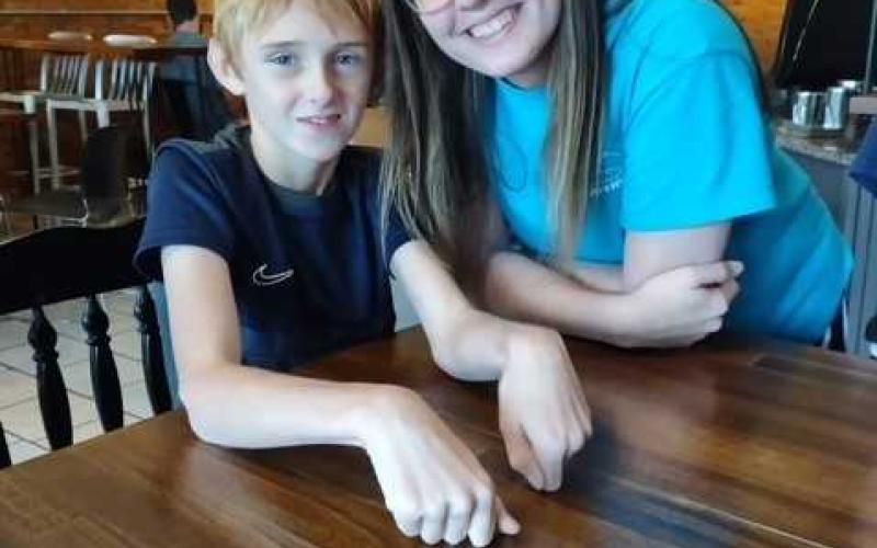 Kaden Phillips and volunteer Gracie Howington hang out at Center Field in downtown Royston.
