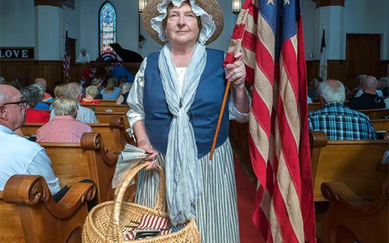Sara Lesseur dons her Nancy Hart attire at the annual 4th of July service at Hartwell First United Methodist Church last month.