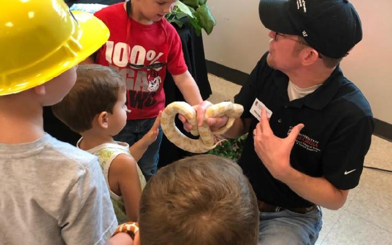 Dr. Nick Furhman shows off Snowy the corn snake to specators at the Northeast Georgia Ag Expo.