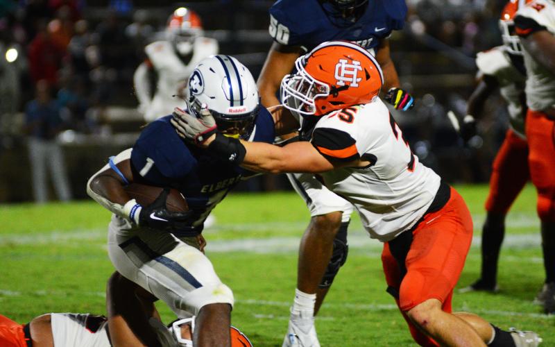 Cyrus Bowen wraps up the Elbert County running back in the backfield on Aug. 19.