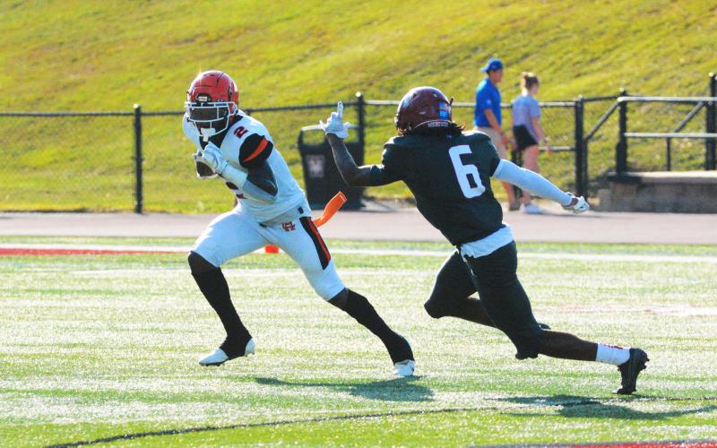 Austen Whitworth lowers his shoulder against a Wren defender on one of his few runs of the game.