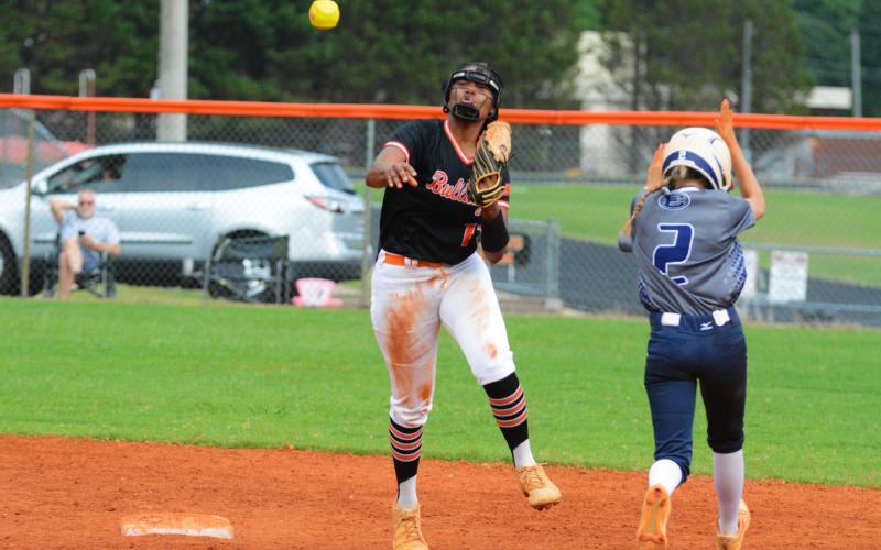 Jazania Shealer throws to first to try to get the double play after tagging second against Elbert County on Tuesday, Aug. 16.