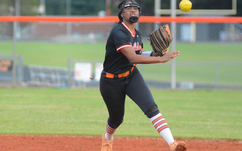 Jazania Shealer throws a runner out at first.