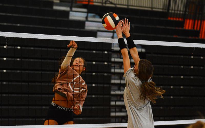 Ryann Williamson blocks a hit from Lillie Kate Rogers at practice.