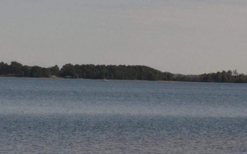 A boat rests far in the distance on Lake Hartwell on Monday morning at the location of a plane that crashed Saturday. Photo taken from Carter's Ferry. (Dan Hunt/The Hartwell Sun]