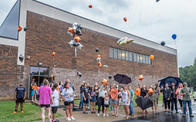 Hart County Middle School students and families gather outside the middle school gym on Sunday evening to raise balloons in memory of their lost peer Lake Fuller, who was killed in a dirt biking incident a day prior.