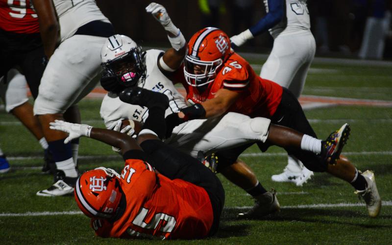 Cyrus Bowen (45) tackles a Knight with the help of Trez Fouch (15).