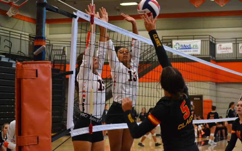 Ryleigh Jordan (left) and Alexis Walker (right) attempt a block against Cedar Shoals on Sept. 15.