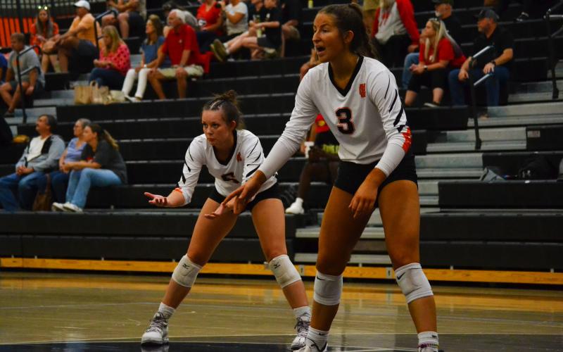 Alexandria Burdette (left) and Lillie Kate Rogers (right) prepare for the serve.