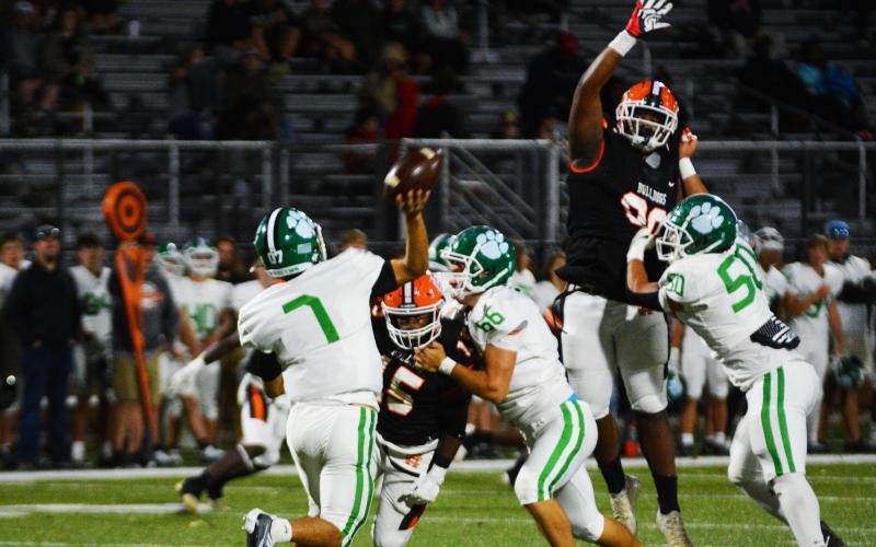 Trez Fouch (left) and Derrick Clarke affect the Lion’s quarterback in the win on Sept. 29.