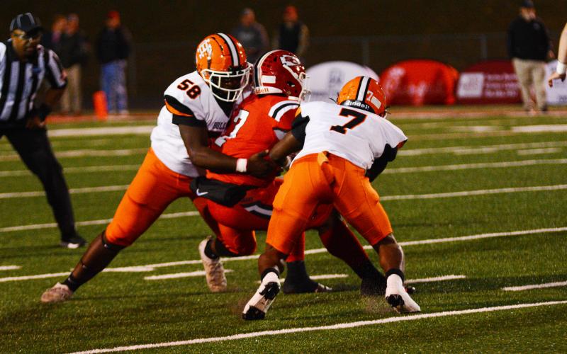 Trevion Jones and Nori Moore bring down a Stephens player.