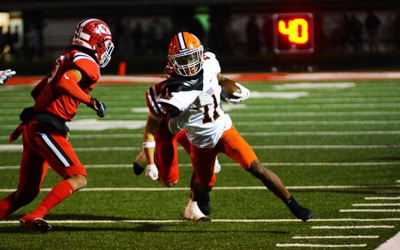 Keith Curry turns up field after catching a pass against Stephens County.