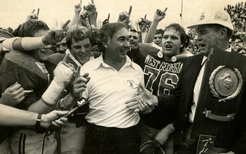 Bobby Pate receives the national championship trophy with his players in 1982.
