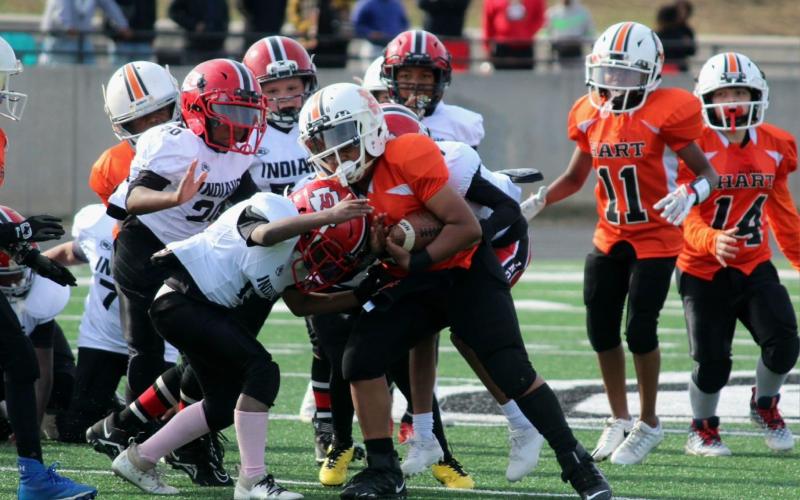 A 9U Hart County Bulldogs running back fights for extra yards in the NGYFA Championship win against Stephen County.