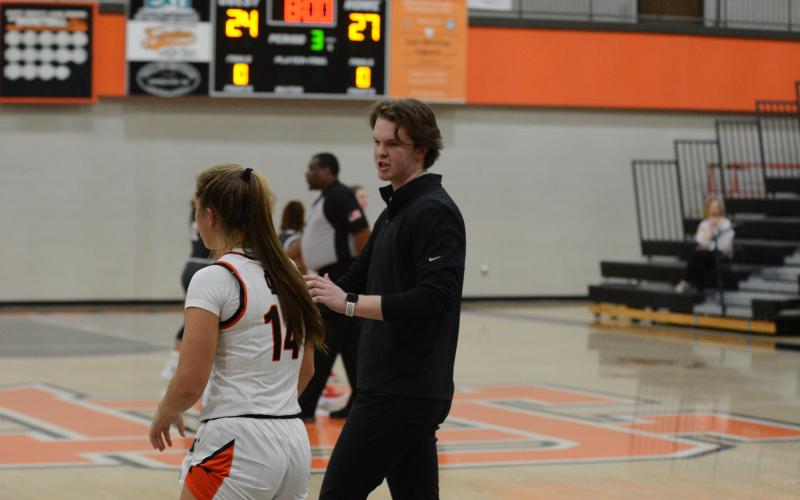 Pictured right, Ben Edwards coaches up junior guard Dakota Phillips in the Madison County win on Nov. 10.