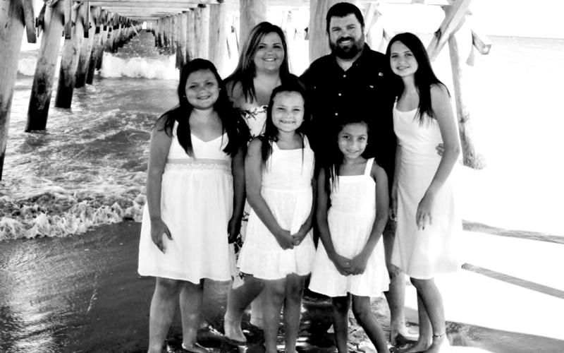 Parents Dustin and Ashley Carruth with their adopted kids (L-R) Sellie, Harper, Evie Rae and Jaydyn,