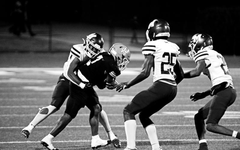 Junior running back Nori Moore attempts to shed the tackle of a Purple Hurricane defender in a tough region loss, 49-14.