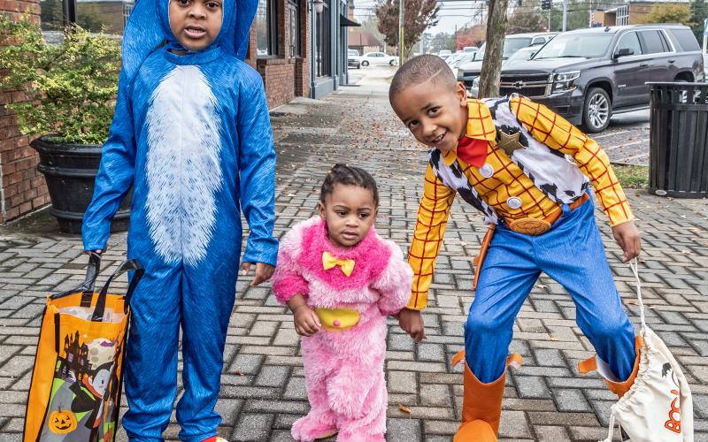 Demetrius Hudson (5), Brintleigh Teasley (1) and Rylen Rucker (4) enjoy Halloween night to the fullest, attending the Mayor’s Monster Mash held along Railroad Street.