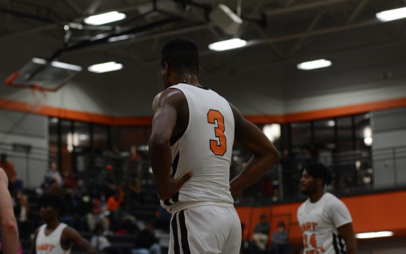 Tahj Johnson stands in along the lane during a free throw.