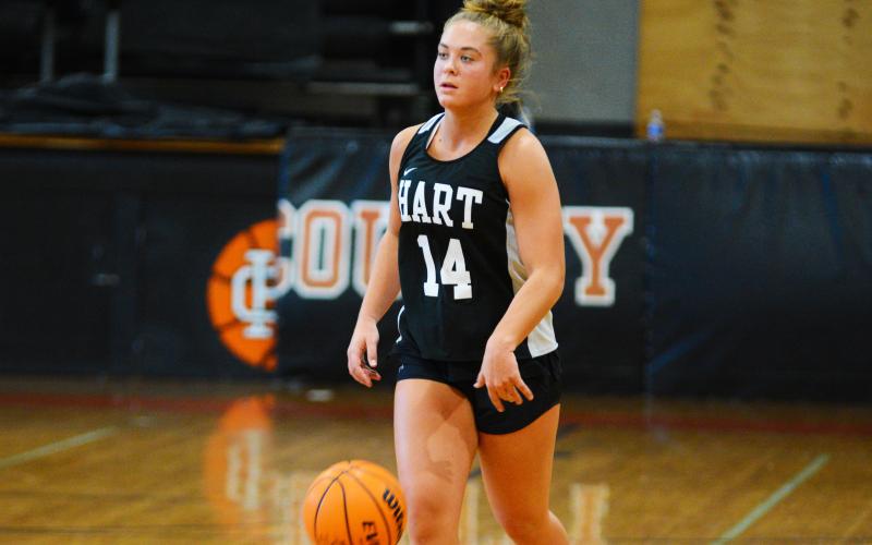 Junior Dakota Phillips brings the ball down the court in a scrimmage to start practice.