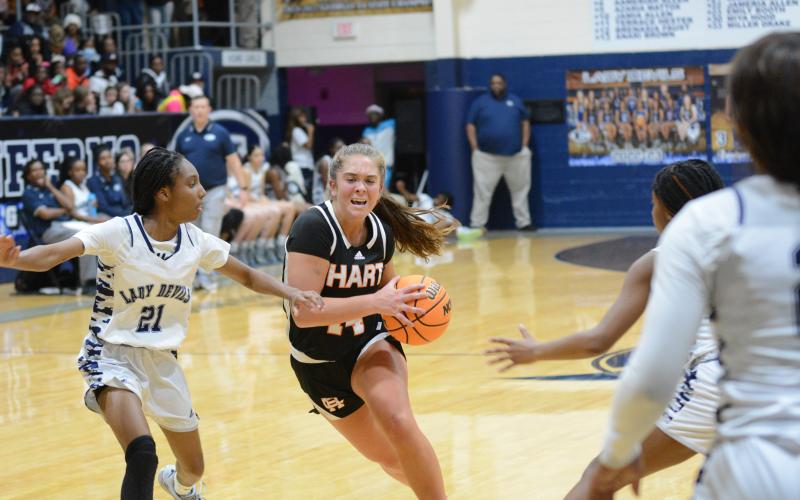 Junior guard Dakota Phillips drives to the basket in the 68-44 loss against Elbert County Tuesday.