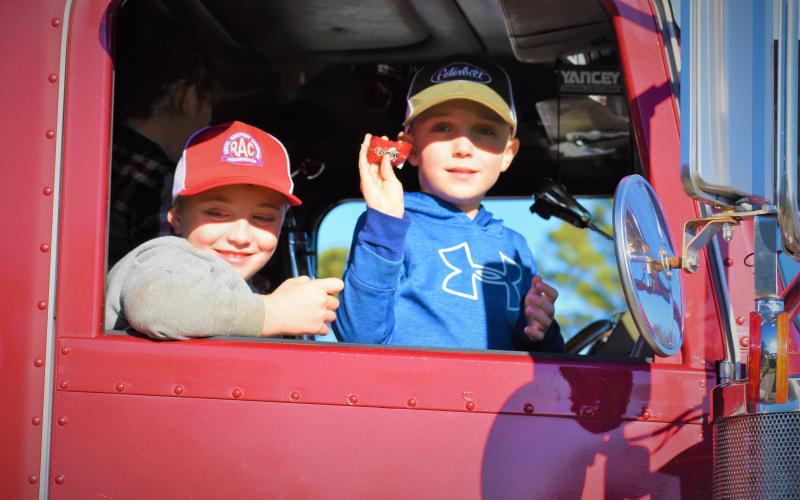 Youngsters toss candy from a rig on Sunday in Hart County.