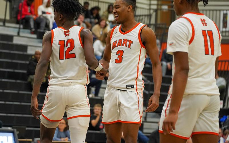 Pictured left to right: senior Terrance Mitchell, senior Tahj Johnson, and junior Jashon Gaines celebrating the 68-55 home win over the Warriors of Oconee County on Friday, Jan. 19. (Photo by Lexie Wheless)