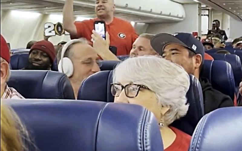 Pictured is a screencap of a video taken of Hartwell resident Brooks Mewborn, who went viral for the scene above, where he started a UGA chant on a plane hours after the school’s second consecutive national championship.
