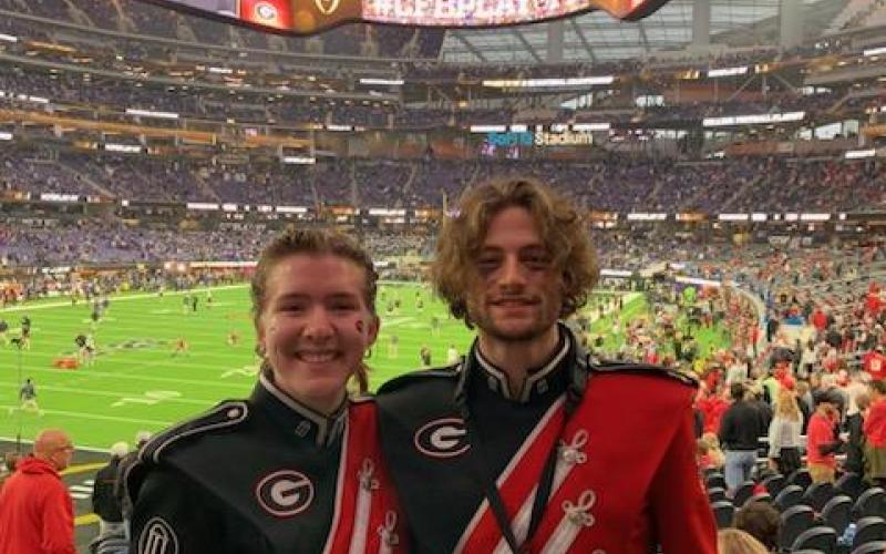 Harli Cleveland, left, and Olin Cordell, members of the Georgia Redcoat Band watched their Bulldogs dismantle TCU and earn a second consecutive national championship.