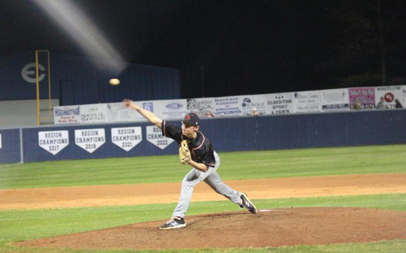 Senior pitcher Reece Maxwell delivers a pitch in the 9-4 road loss to Elbert County  in the season opener on Feb. 8. (Photo by Mark Wells at The Elberton Star)