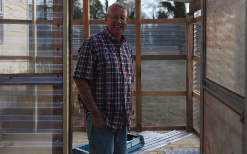 Roger Leopard stands in the greenhouse he is working to build. The couple is eagerly awaiting the upcoming change of seasons when their garden will spring to life.