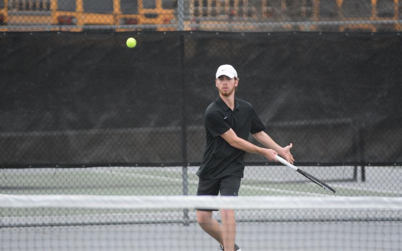 Senior Daniel Leard returns a serve in a 2022 match as the Lady Dogs start 1-0 and the Dogs start 0-1 on the season.