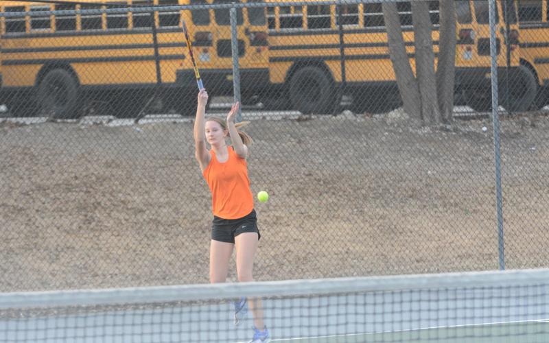 Ava Carnes returning a serve.