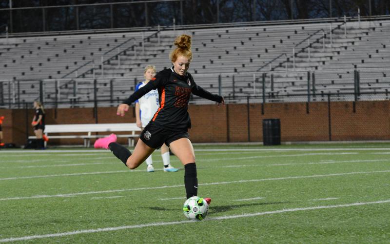 Pictured is sophomore forward Channing Segars scoring one of her three goals in the 8-1 win over Washington-Wilkes on March 10.
