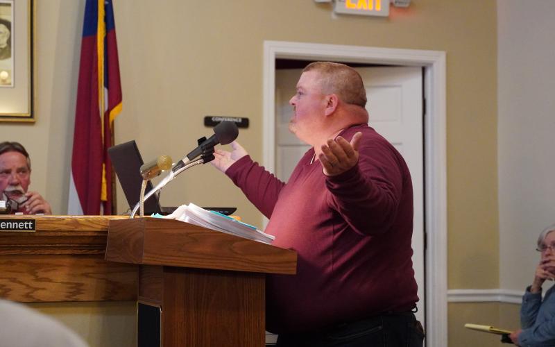Charlie Pierce explains to the board that he should be allowed to build a duplex on his property despite the current moratorium on multi-family residential housing.
