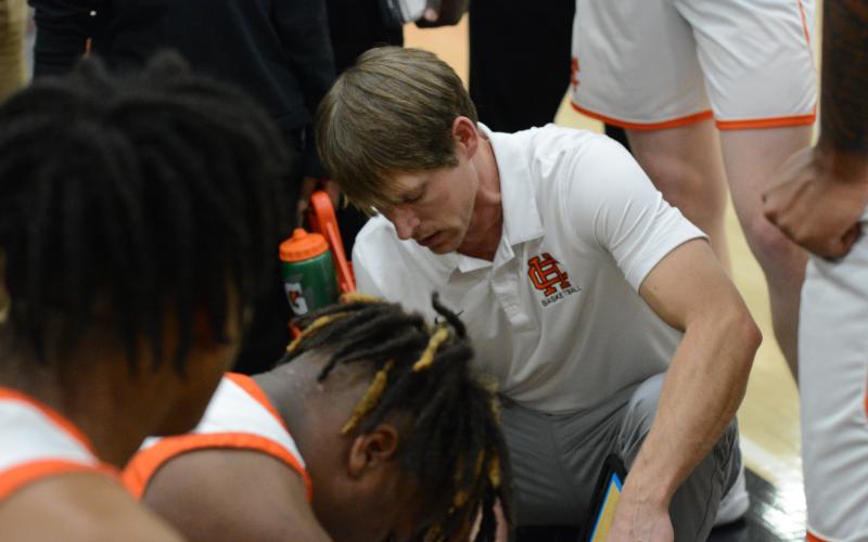Dogs head coach Matt Gibbs draws up a play during a home game from earlier in the season.
