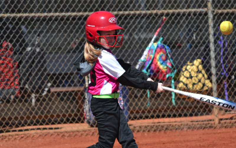 Pictured is Nora Gibbs hitting the ball to left field.