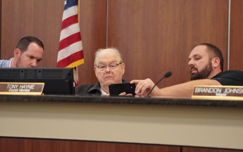 Hartwell City Council members (from left) Dan Leard, Tony Haynie and Mayor Brandon Johnson take a first look at the proposed MLK mural to go downtown off Franklin Street. The council decided to approve funding for a mural, but asked for changes to be made to the original proposed design and would require council approval of the design before moving forward.