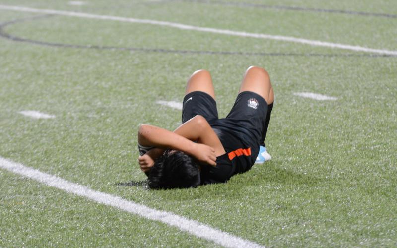 Senior left defensive back Jonathan Velazquez lies down after giving it his all in his final game for Hart County. As the Dogs lose 7-1 on the road to Wesleyan in the first round of the state playoffs.