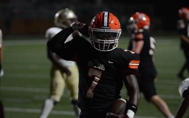 Nori Moore flexes his muscles after a multi-touchdown game performance versus Cross Creek during the 2022 season.