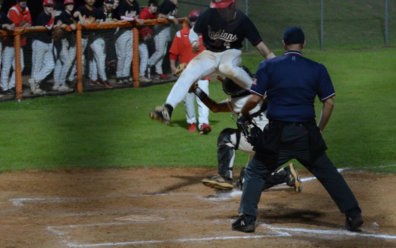 Senior catcher Riley Posey applies the tag on the back leg on the runner to get a crucial out to keep the shutout alive in the 6-0 win over Stephens County in game two on April 13.