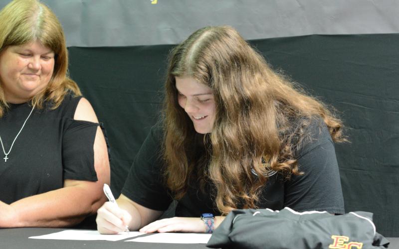 Senior Barnes Academy cheerleader Abbey Johnson (right) signs with Emmanuel College on Monday, May 15 to continue her academic and cheer career with the Lions. Her mom, Vickie Johnson, is pictured left.