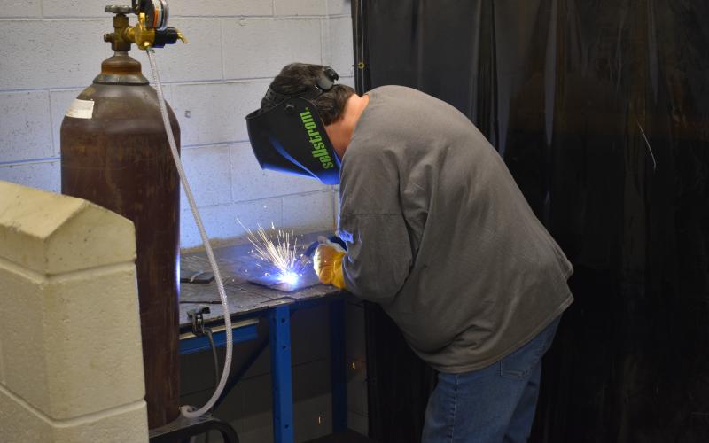 Sue Couch, a participant in the second installment of the adult welding class, works on her final project at the end of the four-week course.